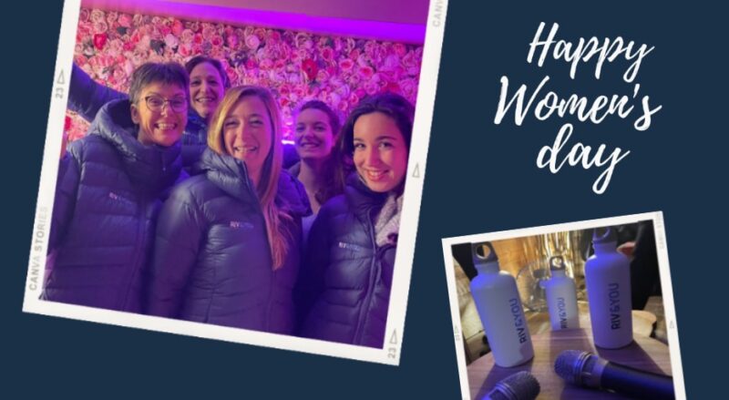 Women celebrating International Women's Day with branded water bottles