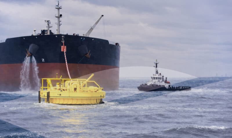 Large tanker ship connecting to yellow offshore mooring buoy at sea